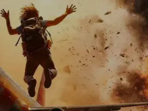 Person by plane with blast in the background