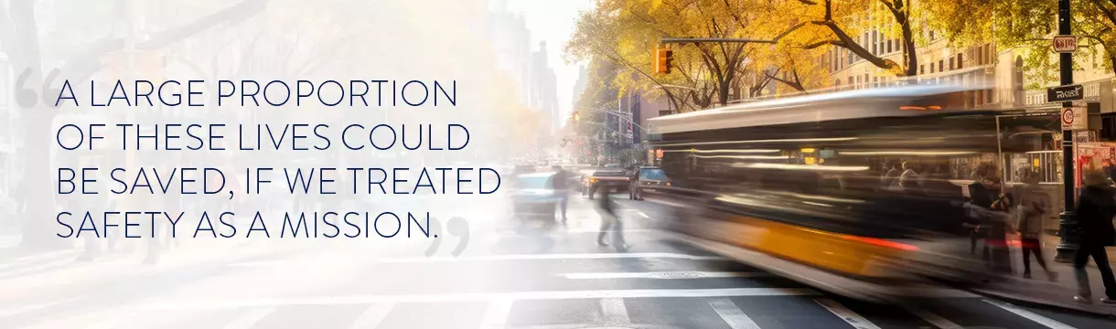 busy intersection in a City with quote "A Large portion of these lives could be saved, if we treated Safey as a Mission."